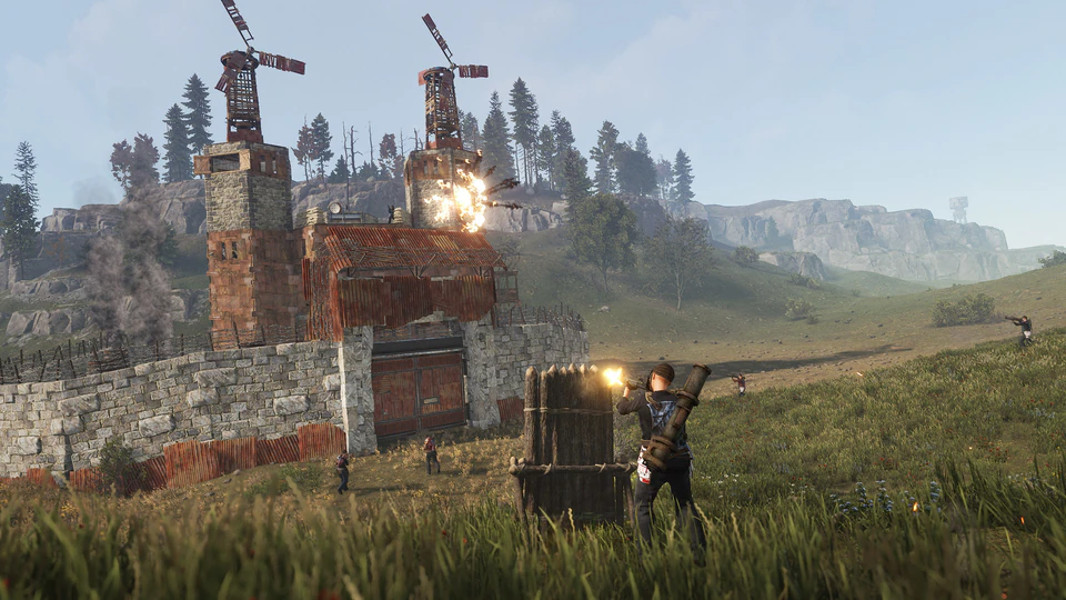Rust firefight with players engaging around stone ruins at sunset